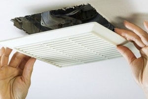 hands adjusting a ceiling vent cover