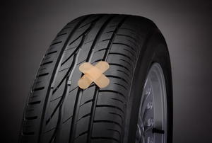 A pair of bandages on a tire. 