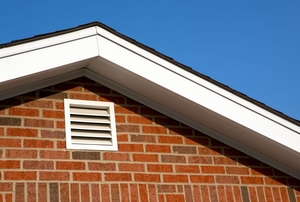 Soffit vents in an attic.