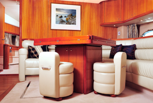 inside of a boat with white furniture and wood accents