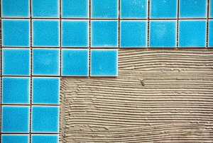 blue ceramic tiles being put down