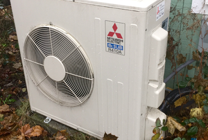 A ductless heating unit on the outside of a home.