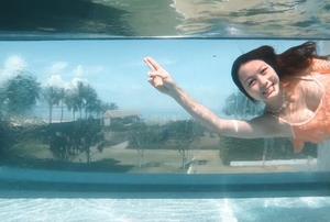 girl swimming in transparent pool