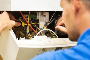 A man works on a water heater.