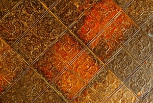 A close-up of some ornate, tin ceiling tiles.
