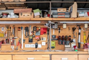 organized workshop with tools hanging on wall