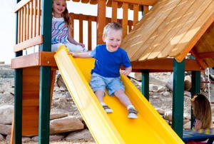 young boy on slide at playground