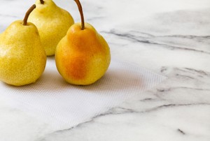 Three pears on a marble surface