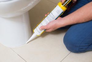 caulking the base of a toilet
