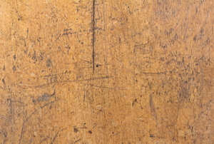 A wooden table top with a medium-sized crack.