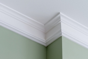 White crown molding on a green painted wall