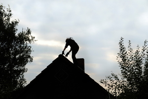 A man on a roof.