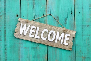 A wood welcome sign.
