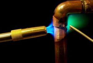 Soldering a copper elbow.