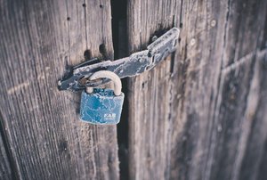 Rustic wood shed with padlock on the door