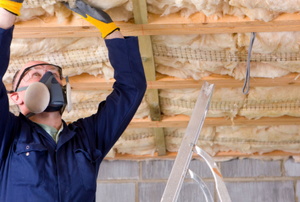 worker installing basement insulation