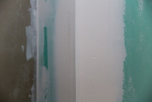 An outer corner formed from greenboard drywall.