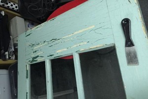 A vintage French door in need of a new paint job.