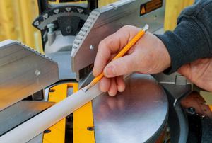 Marking a cut on a piece of quarter round molding