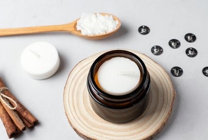 ingredients for making soy candles, including wax, cinnamon, and a wood spoon