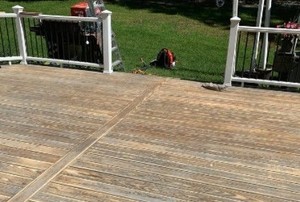 a gray deck in the process of restaining