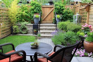 An outdoor patio with plants and a dining set.
