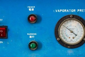 a blue evaporator with a switch, lights, and pressure meter