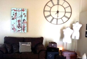A modern living room with a recycled pallet as wall art.