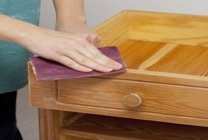 sanding a varnished side table