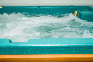 A turquoise hot tub with bubbles. 