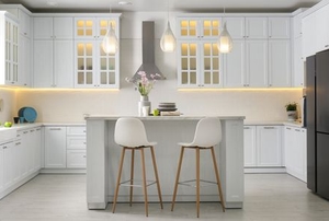 clean, modern kitchen with hanging lights and island with stools
