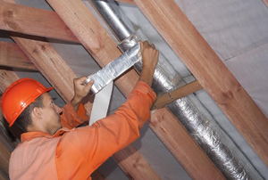 a man taping ductwork