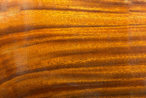 A glossy, lacquered wood surface.