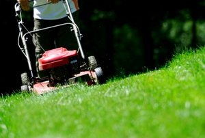 A mower cutting across a steep slope.