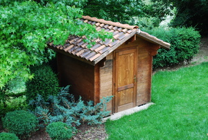 Wood shed in a landscaped yard