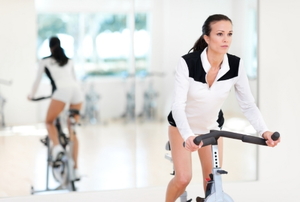 Young Woman On Exercise Bike