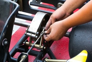 person working on go kart engine