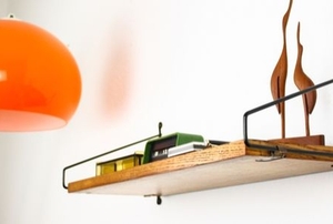 shelf on wall with metal brackets and orange light