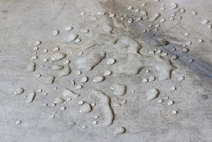 Water beading up on concrete surface