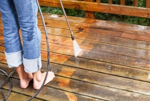 A wood deck with a pressure washer.