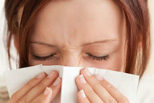 A woman overcome by allergies.