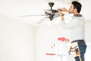 Man installing a ceiling fan