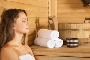 Woman relaxing in a sauna