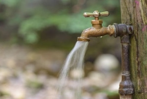 outdoor water spigot on wood post