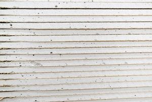 A close-up image of a stack of drywall.
