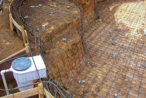 Pool construction with wire and wood forms. 