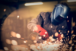 Person in safety gear grinding metal