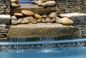 A waterfall water feature with rocks.