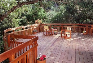 A redwood deck surrounded by oak trees.