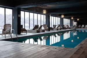 an indoor pool surrounded by windows